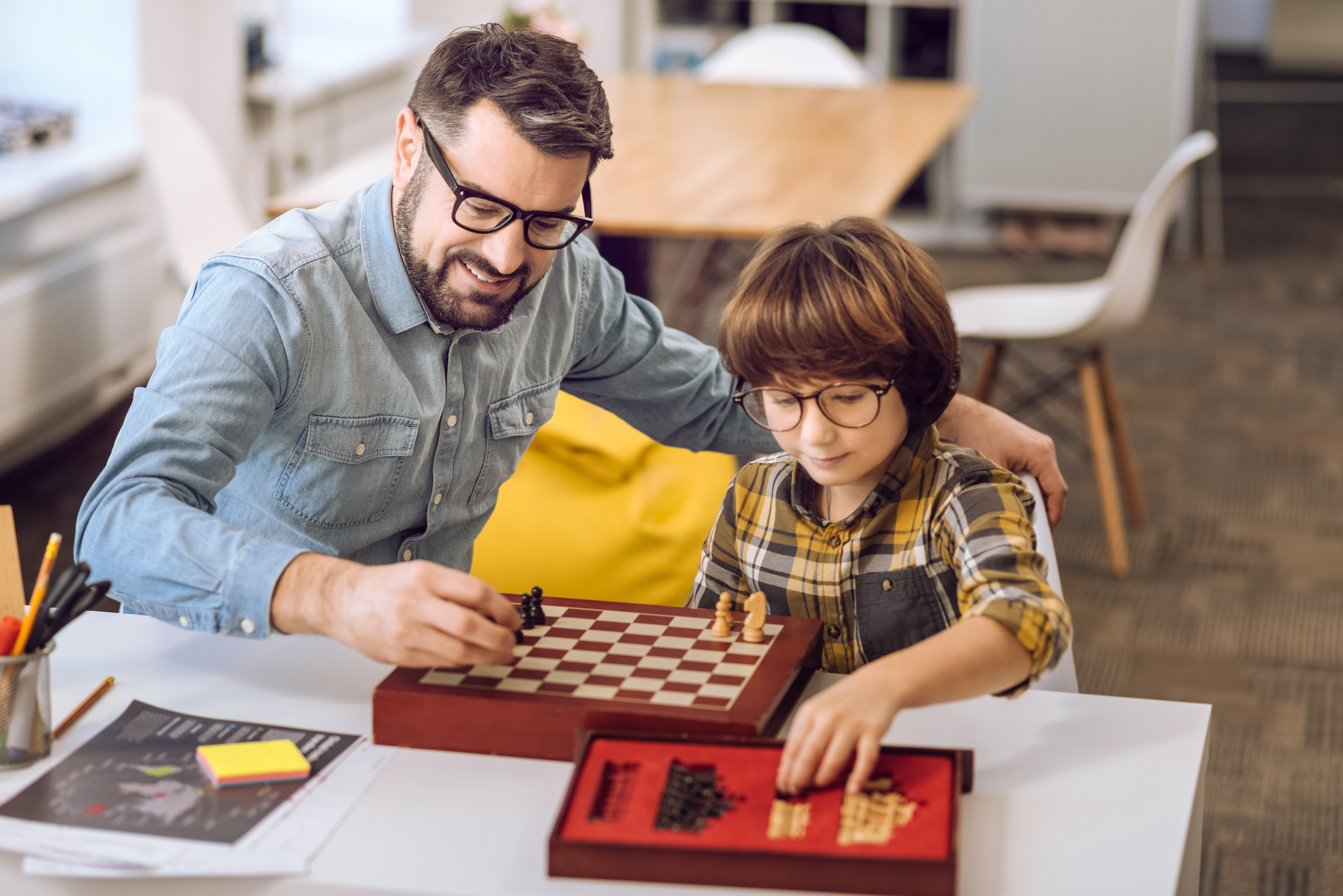 Family playing chess with glasses